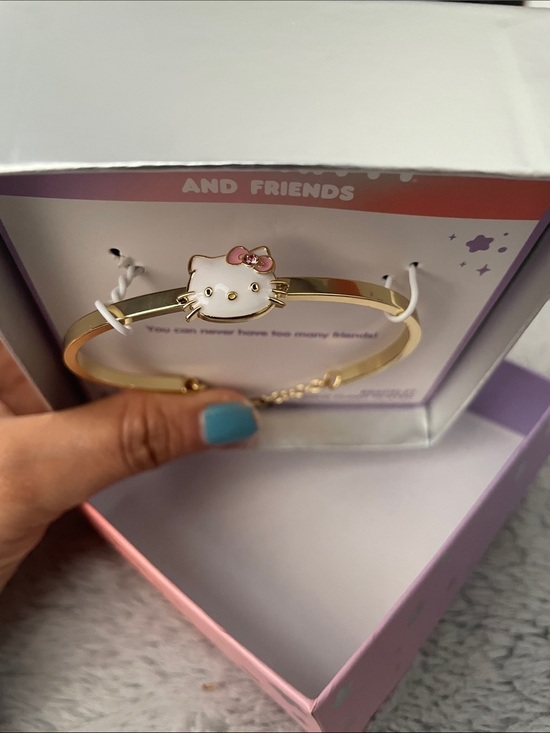 Hello Kitty Jewelry - Hello Kitty Gold and White Enamel Bracelet with Pink Bow Accent